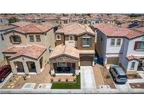 Two-story home with a stone accent front porch and desert landscaping in a dense suburban neighborhood at 7694 Hampton Park Ln, Las Vegas, NV 89113