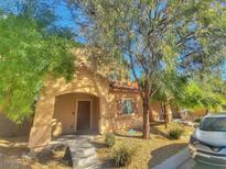 Charming two-story home with a front porch, desert landscaping, and mature trees in a residential neighborhood at 8928 Harmony Hall Ave, Las Vegas, NV 89178