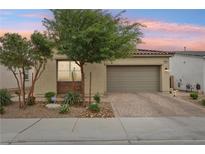 Charming single-story home with a well-maintained front yard and two-car garage, nestled in a quiet neighborhood at 8956 Skye Treeline St, Las Vegas, NV 89166