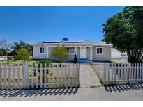 Charming single-story home with a white picket fence and well-maintained front yard at 1123 Chapman Dr, Las Vegas, NV 89104