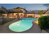 Inviting backyard pool and spa featuring a spacious deck and a charming upper-level balcony with mountain views at 1251 Los Meadows Dr, Las Vegas, NV 89110
