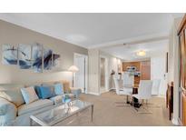 Relaxing living room featuring comfortable seating, neutral tones and easy access to the kitchen and dining area at 135 E Harmon Ave # 1621, Las Vegas, NV 89109