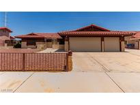 Charming home featuring a red tile roof, low maintenance landscaping, and an attached two-car garage at 1513 Brocado Ln, Las Vegas, NV 89117