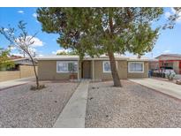 Charming single-story home featuring desert landscaping and mature shade trees at 2408 Berkley Ave, Las Vegas, NV 89101