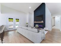 Bright living room featuring a fireplace, modern furnishings, and patio access to the backyard pool at 3409 El Cortez Ave, Las Vegas, NV 89102