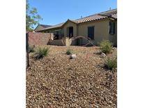Landscaped front yard with desert plants and rock cover, offering low-maintenance appeal to the home at 3484 Bradano Ln, Henderson, NV 89044