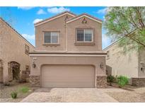 Charming two-story home with a beige exterior, stone accents, and a spacious two-car garage at 367 Wilford Springs St, Henderson, NV 89014