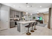 Modern kitchen featuring a spacious island, stainless steel appliances, and an open layout at 4537 Cloudrest Peak St, North Las Vegas, NV 89031
