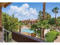 Relaxing condo community featuring a sparkling pool, mature palm trees, and well-maintained landscaping at 5166 S Jones Blvd # 205, Las Vegas, NV 89118