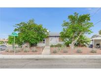 Charming single-story home with mature trees, desert landscaping, and a chain-link fence at 601 Huntington St, Las Vegas, NV 89107