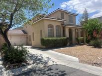 Charming two-story home with a two-car garage, desert landscaping, and a spacious driveway at 6797 Cardoness Ct, Las Vegas, NV 89139