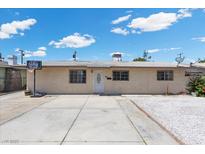 Single-story home with a concrete driveway, white gravel accents, and a basketball hoop for recreational fun at 808 Reynolds Ave, North Las Vegas, NV 89030
