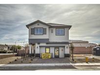 Two-story model home featuring a gray and white color scheme and eye-catching architectural details at 8447 Sycamore Creek St, Las Vegas, NV 89148
