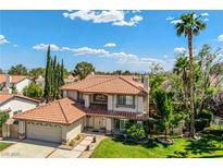 Charming two-story home featuring a tile roof, landscaped yard, and attached two-car garage at 9021 Feather River Ct, Las Vegas, NV 89117