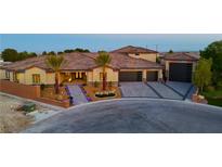 Stunning home exterior featuring mature palms, desert landscaping and a spacious three car garage at 9865 Bright Angel Way, Las Vegas, NV 89149
