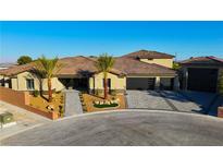 Stunning single-story home featuring a tile roof, desert landscaping, and a three-car garage at 9865 Bright Angel Way, Las Vegas, NV 89149
