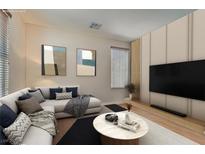 Bright living room with neutral walls, modern decor, and large windows for natural light at 987 Wembly Hills Pl, Henderson, NV 89011