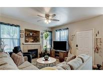Inviting living room featuring a ceiling fan, fireplace, and comfortable seating at 9975 Peace Way # 1069, Las Vegas, NV 89147