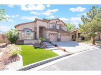 Charming two-story home featuring a three-car garage, manicured lawn, and a welcoming entrance at 1016 Eaglewood Dr, Las Vegas, NV 89144