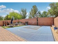 Outdoor basketball court featuring a lounge area, encased by a brick wall and brick paver trim at 10329 Walworth Ave, Las Vegas, NV 89166