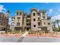 Beautiful multi-story building with desert landscaping and a unique rounded tower feature at 128 Los Cabos Dr # 301, Las Vegas, NV 89144