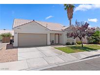 Charming single-story home featuring a desert landscape, two-car garage, and beautiful tile roof at 1728 Crystal Chimes Dr, Las Vegas, NV 89106
