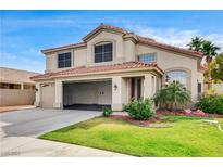 Charming two-story home with a tile roof, spacious three-car garage, and well-manicured front lawn at 313 Vista Glen St, Las Vegas, NV 89145