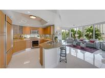 Open concept kitchen with stainless appliances and granite countertops flows into the living room at 322 Karen Ave # 308, Las Vegas, NV 89109