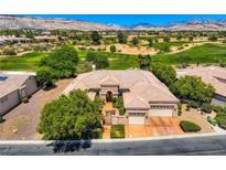Stunning aerial view of a home on a golf course, showcasing its tile roof and lush landscaping at 4719 Riva De Romanza St, Las Vegas, NV 89135