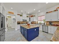 Bright kitchen boasts a large island, granite countertops, and stainless steel appliances at 7408 Via Fiorentino St, Las Vegas, NV 89131