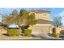 Two-story home with a beige exterior, a two car garage and professional landscaping at 8036 Eurostar St, Las Vegas, NV 89131