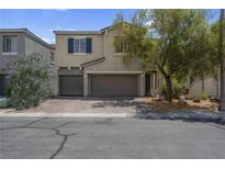 Inviting two-story home featuring a well-maintained front yard, dual-car garage and cozy curb appeal at 9840 Chief Sky St, Las Vegas, NV 89178