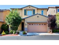 Charming two-story home featuring a stucco facade, well-manicured landscaping, and an attached two-car garage at 10449 Yew Blossom Ave, Las Vegas, NV 89166