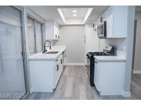 This kitchen has white cabinets, a black faucet, modern appliances, and plenty of counter space at 1440 Vegas Valley Dr # 3, Las Vegas, NV 89169
