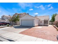 Charming single-story home with an attached garage and well-maintained landscaping on a sunny day at 1740 Leaning Pine Way, Las Vegas, NV 89128