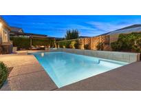 Stunning backyard pool and spa with an outdoor living space for relaxation and entertainment in the evening at 6192 Lautman Ridge Ct, Las Vegas, NV 89141