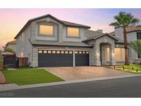 Charming two-story home featuring a gray two-car garage, landscaped front yard, and inviting entryway at 6639 Tranquil Seas Ct, Las Vegas, NV 89139