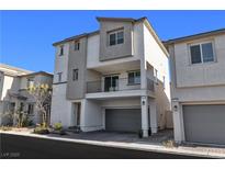 Contemporary three-story townhome with a private balcony and a two-car garage at 6952 Crescent Gold St, North Las Vegas, NV 89086
