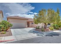 Charming single-story home with a well-manicured front yard and a two-car garage at 7908 Morning Gallop Ct, Las Vegas, NV 89131