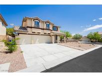 Charming two-story home with stucco exterior, three-car garage, and manicured landscaping at 8224 Cassis Ct, Las Vegas, NV 89117