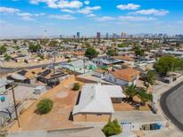 Expansive aerial view of a residential area with city skyline and blue skies in the background, showcasing neighborhood at 829 Dover Pl, Las Vegas, NV 89107