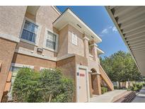 Exterior view of a stucco condo building with visible stairs and landscaping at 830 Carnegie St # 824, Henderson, NV 89052