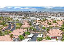 Community aerial view of red tile roofs and landscaping, with the Las Vegas skyline in the distance at 950 Seven Hills Dr # 124, Henderson, NV 89052