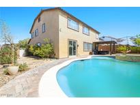 Backyard pool view showcases refreshing water, covered patio, and outdoor leisure space at 1141 Brent Park Ct, Henderson, NV 89002