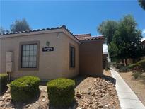 Inviting exterior of a well-maintained building with a red tile roof and desert landscaping at 2041 Hussium Hills St # 104, Las Vegas, NV 89108