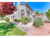 Charming two-story home with beautiful landscaping, mature trees, and a well-maintained stucco facade at 208 Genesee Point St, Henderson, NV 89074