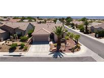 Charming single-story home featuring a tile roof and desert landscaping including a palm tree at 2221 River Grove Dr, Henderson, NV 89044