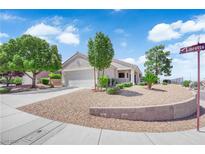 Charming single-story home with xeriscaped front yard, three trees, and two-car garage at 2504 Libretto Ave, Henderson, NV 89052