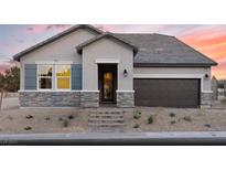 Beautiful single-story home featuring stone accents, a two-car garage, and desert landscaping at 2615 Regency Cove Ct # Lot 13, Las Vegas, NV 89121