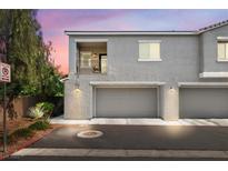 Charming two-story townhome featuring a private balcony and attached two-car garage with a stucco facade at 2860 Sunflower Days Ave # 2141, North Las Vegas, NV 89031